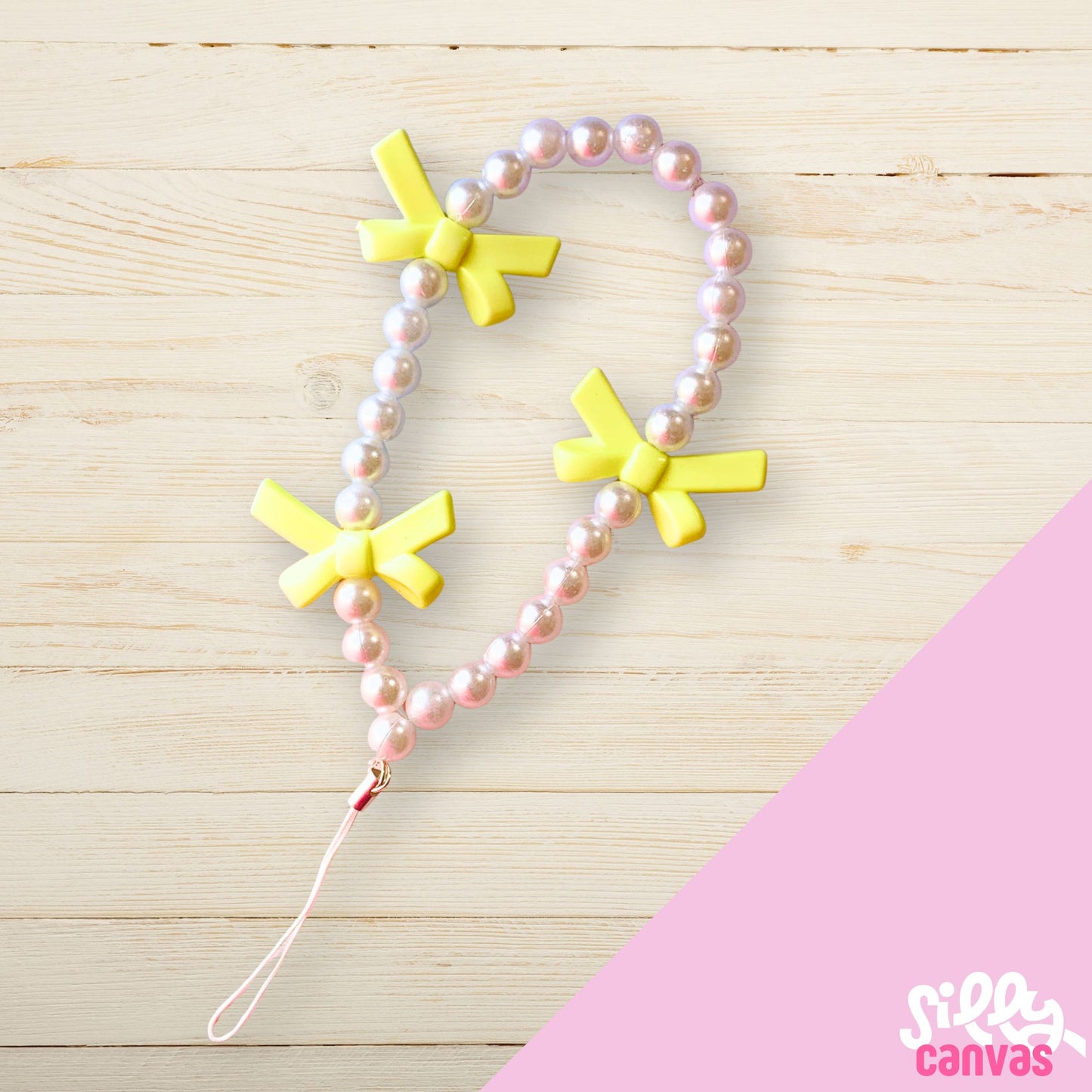 Yellow bow phone charm with white beads