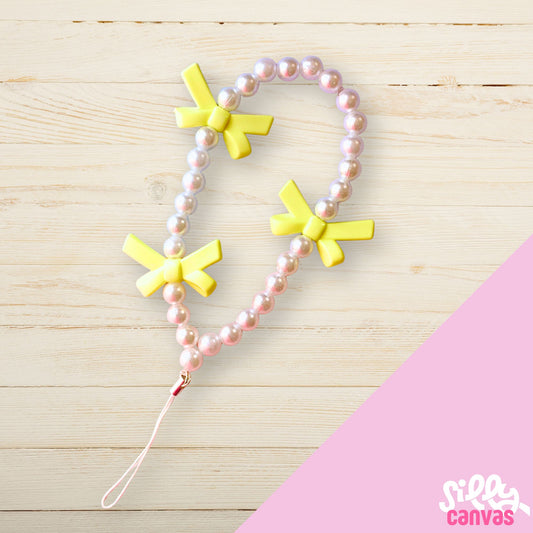 Yellow bow phone charm with white beads